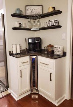 a kitchen with white cabinets and black counter tops