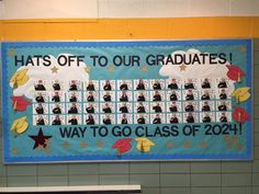 a bulletin board hanging on the wall in a school hallway that says hats off to our graduates way to go class of 202