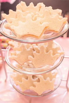 three tiered trays filled with cookies on top of a table