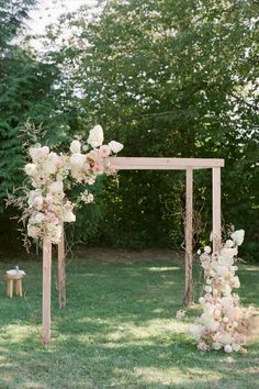 an outdoor ceremony setup with flowers and greenery