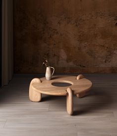 a wooden coffee table with a vase on top