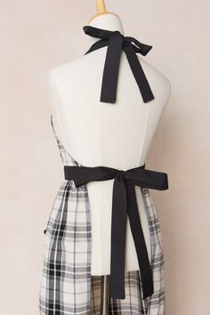 Be the ultimate kitchen fashionista with our Ivy Apron in Laura Plaid Cotton. Featuring a darling black and white plaid print, with a functional square neckline and waist ties, as well as a midi-length skirt with pockets and a charming ruffle hem. This apron makes cooking stylish and convenient. Don't just cook, make a statement in this 100% cotton beauty! White Bridal Dresses, Ultimate Kitchen, City Woman, White Dress Party, Fabulous Fall, Black And White Plaid, Bridesmaids And Groomsmen, Fall Fits, Midi Length Skirts