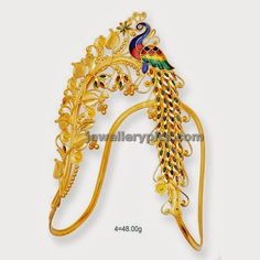 a gold brooch with a peacock on it