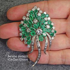 Stunning burst of vivid green emeralds and sparkly white diamonds covering all the surfaces of this beautiful platinum vintage brooch! Total Weight: 29.15 grams Size: 2.5 inch tall, 1.5 inch wide Precious Metal: Platinum Precious stones: -Emeralds: QTY: 31, 2.7mmx4.7mm to 4.2mmx6.3mm size, 7.5 carats -Diamonds: 29 rounds, 20 baguettes, 6 carats Green Diamond Wedding Brooches, Vintage Green Diamond Brooches, Fine Jewelry Green Gemstone Brooches, Luxury Green Brooches For Wedding, Fine Jewelry Green Brooch For Anniversary, Fine Jewelry Green Brooches For Anniversary, Green Fine Jewelry Brooch For Anniversary, Luxury Green Brooch For Anniversary, Luxury Green Brooches For Anniversary