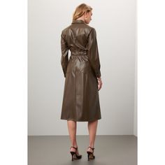 Green faux leather (100% Polyurethane). Shirt dress. Long sleeves. Collar. Front button closure. 48" from shoulder to hemline. Imported. Sleek Leather Dress For Fall, Sleek Faux Leather Dresses For Fall, Sleek Collared Fall Dress, Fall Faux Leather Knee-length Dress, Faux Leather Knee-length Fall Dresses, Faux Leather Knee-length Dresses For Fall, Fall Leather Dress With Button Closure, Leather Fall Dress With Button Closure, Spring Leather Dresses With Button Closure