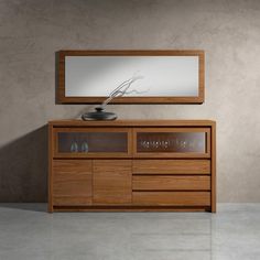 a wooden cabinet with glass doors and a mirror on it's side, in front of a wall