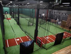 an indoor batting cage with seats and equipment