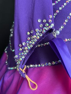 the purple dress is adorned with crystal beads