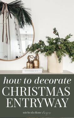 a christmas entryway decorated with greenery and gold bells on the top of a dresser