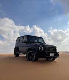 a black jeep is parked in the desert