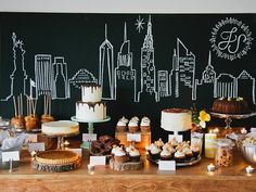 a table topped with lots of cakes and cupcakes