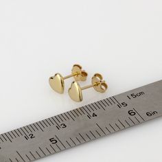 These are small gold heart earrings, handmade of 14k solid gold. Modern yellow gold heart stud earrings, with a highly shiny finish. These heart studs are perfect for every day's wear, and will look great with any style. They will add a chic gold touch and sparkle to your appearance. A wonderful gift for yourself or for someone you love. Heart's size is approx 6.8 x 6.2 mm = 0.26 x 0.24 inch Heart is 1.4 mm thick = 0.05 inch. 14k solid gold ear backs are included. *I can make these earrings in m Gold Heart Stud Earrings, Red Garnet Earrings, Gold Heart Studs, Gold Heart Earring, Minimalist Earrings Gold, Triangle Studs, Valentines Day Gifts For Her, Garnet Earrings, Heart Studs