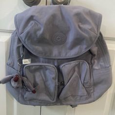 Kipling “Fiona” Backpack, Dove Grey Features Nylon Dimensions: 13.25''L X 13.25''H X 6''D Weight: 1.1 Lbs Volume: 14l Adjustable Backpack Straps Two Front Zip Pockets Two Side Slip Pockets Flap Closure With Magnetic Snap Top Carry Handle Internal Zip And Slip Pockets Monkey Keychain Monkey Keychain, Kipling Bags, Light Lilac, Lilac Color, Dove Grey, Backpack Straps, Zip Pockets, Lilac, Bag Lady