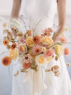 a bride holding a bouquet of flowers in her hands