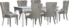 a dining room table and chairs with silver legs