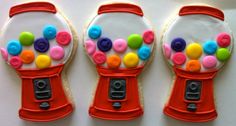 three decorated cookies in the shape of gummy machines