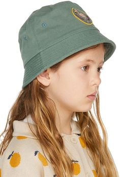 Cotton twill bucket hat in khaki. Embroidered graphic patch in khaki, pink, yellow, and burgundy at face. · Eyelet vents embroidered at crown · Quilted brim · Cotton twill browband · Unlined · Hand wash Supplier color: Khaki Jellymallow Size: Head Circumference 50: 19.5 / 50 cm 54: 21.3 / 54 cm Khaki Cotton Bucket Hat With Curved Brim, Khaki Cotton Bucket Hat With Short Brim, Khaki Brimmed Cotton Bucket Hat, Casual Cotton Sun Hat In Khaki, Khaki Cotton Wide Brim Bucket Hat, Casual Khaki Cotton Sun Hat, Casual Khaki Bucket Hat With Flat Brim, Spring Bucket Hat With Curved Brim, Yellow And Burgundy