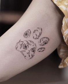 a dog paw tattoo on the leg