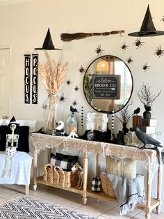 a living room decorated for halloween with decorations on the wall and decor around the fireplace