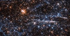 an image of stars in the sky with bright lights and blue, white and orange colors