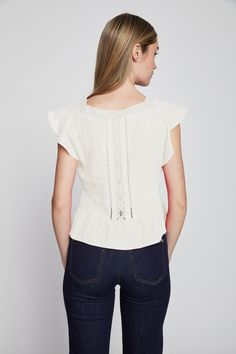 Linen top with lace and front pleating detail. Fitted Chic Lace Top, Fitted Lace Top In Chic Style, Chic Embroidered Top With Ruffles, White V-neck Top With Smocked Back, Feminine Tops With Smocked Back For Daywear, White V-neck Tops With Smocked Back, Chic Fitted Ruffle Top, Chic Fitted Top With Ruffles, Chic Fitted Ruffled Tops