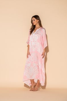 This damask print is a lovely combination of pale pink and white in our Romantique long caftan. The long, flowing caftan is made out of our signature Polysilk fabric for that all-day luxe vibe. Cover-up? Sure. Loungewear? Why not? Brunch with friends? Definitely. Sleepwear? Absolutely. Machine washable for ease of care. Elegant Pink V-neck Kaftan, White Maxi-length Kaftan For Loungewear, White Maxi Kaftan For Loungewear, White Maxi Length Kaftan For Loungewear, Pink Silk Kaftan For Vacation, White Silk Dress For Loungewear, Elegant White Kaftan For Daywear, White Silk Kaftan With Kimono Sleeves, Elegant Long Pink Kaftan