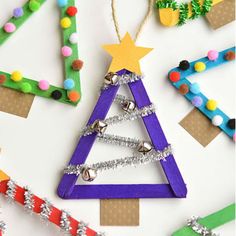 christmas tree ornaments made out of popsicle sticks and colored beads on a white background