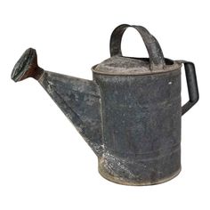 an old metal watering can with a wooden handle