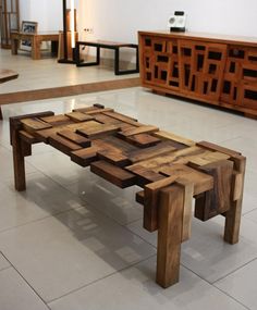 a table made out of wooden blocks in a room with white tile flooring and furniture