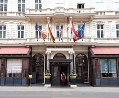 a hotel entrance with flags flying outside