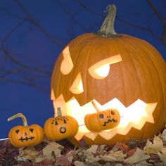 three pumpkins with faces carved into them