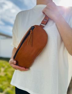 Beautiful handmade Guatemalan leather cross bag/ fanny pack. Made with premium quality Guatemalan leather featuring 2 zipper closures and a adjustable strap.Very lightweight and sturdy.With a deep main pocket for phones, make-up, accessories, keys and a slim secure back pocket for cards and cash.Each piece is handmade featuring a unique design.As a unique handmade product each product may vary.No two are exactly the same and imperfections are to be expected and appreciated. MEASUREMENTSBag: 10"x6"Strap Length: 30 inches (inner circumference)(approximately)As a handmade product size may vary. MATERIAL100% Guatemalan Leather Leather Belt Bag With Zipper Pouch For Everyday, Everyday Leather Chest Bag With Cell Phone Pocket, Leather Chest Bag Pouch With Cell Phone Pocket, Leather Pouch Chest Bag With Cell Phone Pocket, Leather Chest Bag With Cell Phone Pocket, Crossbody Belt Bag With Zipper Pocket, Brown Crossbody Belt Bag With Zipper Pouch, Everyday Carry Crossbody Belt Bag With Zipper Pocket, Brown Crossbody Belt Bag With Zipper