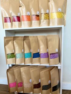 there are many bags on the shelves with different types of beads in them, and one bag is open to show what's inside