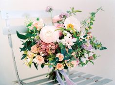 a bouquet of flowers sitting on top of a white chair