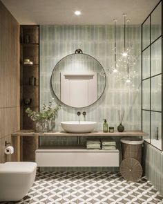 a bathroom with a round mirror above the sink and toilet in front of it, surrounded by tiled walls