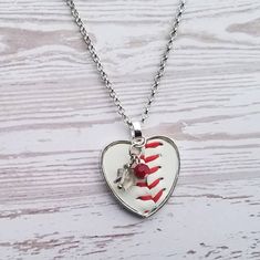 This simple and fun heart pendant is made from a real baseball! Includes white bead. Components are all silver. Chain is stainless steel and measures 18 inches. Please remember...every item is handmade, so no two items will be exactly the same, even if it is the same design. This makes your item one of a kind! Hypoallergenic White Heart Necklace, Nickel Free White Heart Necklace, White Stainless Steel Jewelry With Heart Charm, Personalized White Stainless Steel Charm Necklace, White Stainless Steel Heart Pendant Jewelry, Nickel-free White Heart Necklace, Nickel Free Heart-shaped White Necklace, White Heart-shaped Hypoallergenic Necklace, Heart-shaped Ball Chain Necklace Gift