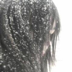 the back of a woman's head covered in snow