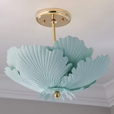 the light fixture is hanging from the ceiling in the room with white walls and ceilings