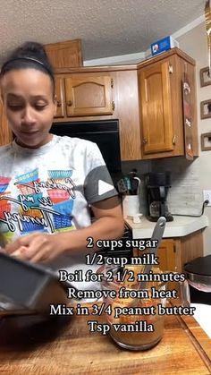 a girl is using a laptop in the kitchen with instructions on how to use it