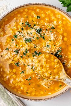 a bowl filled with soup and topped with parmesan cheese