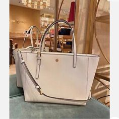 Brand New Ivory Color Saffiano Leather Classic White Shoulder Bag With Gold-tone Hardware, White Shopping Bag With Gold-tone Hardware, White Shopping Bags With Gold-tone Hardware, Classic White Satchel Shoulder Bag, Classic White Everyday Bag, Classic White Shoulder Bag With Removable Pouch, Classic White Shoulder Bag With Double Handle, Classic White Crossbody Shoulder Bag, Classic White Shoulder Bag With Top Handle