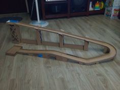 a wooden train track laying on the floor