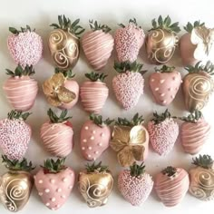 chocolate covered strawberries are arranged in the shape of hearts and swirls on a white surface