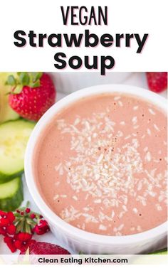 a bowl of vegan strawberry soup with strawberries and cucumbers in the background