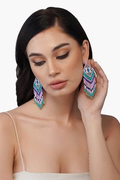 One of our favorite 90's trends is back, but with a cool-girl edge that's ageless and a bit more sophisticated. The beautiful Ella hand beaded earrings are shades of lilac, teal and blue and hand crafted by skilled artisans. They feature bead fringes detail and are the perfect addition to any outfit. Style with your favourite pastel dresses, a pair of flats and a mini bag for a coherent chic look. Handmade by artisans in India. Beautiful Ella Earrings Hand beaded Shades of Lilac, Teal and Blue H Elegant Lavender Beaded Earrings, Luxury Blue Beaded Earrings, Artisan Blue Earrings With Beaded Fringe, Blue Hand-strung Beaded Earrings, Shades Of Lilac, Unique Blue Beaded Earrings Nickel-free, Pastel Dresses, Hand Beaded Earrings, 90s Trends