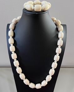 This is a traditional West African off-white beaded necklace. These jewelry pieces are unisex and are designed to be worn by adults Beads are made of resin Length ( from neck to chest): 14 inches *** Each Necklace comes with a matching bracelet These beaded jewelry is an integral part of West African culture. Traditionally it is worn by Royalty, Chiefs, and those who are part of the Royal households among many kingdoms in West Africa. It is also worn by brides and grooms during their wedding cer White Wooden Beads Jewelry, White Wooden Beaded Jewelry, Adjustable Cream Beaded Necklaces With Large Beads, Vintage White Beaded Necklace With Wooden Beads, Adjustable Cream Jewelry With Wooden Beads, Adjustable Cream Jewelry With Large Beads, Cream Jewelry With Large Beads For Gift, Cream Jewelry With Large Beads As A Gift, Elegant White Jewelry With Wooden Beads