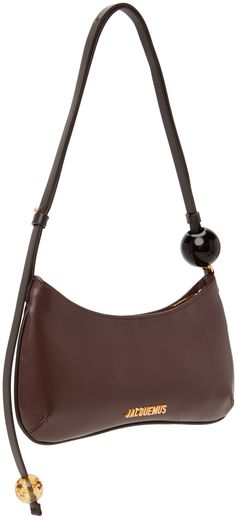 Buffed leather shoulder bag in brown. Logo hardware at face. · Beaded detailing at adjustable shoulder strap · Zip closure · Patch pocket at interior · Twill lining · Logo-engraved gold-tone hardware · H5.25 x W10 x D0.75 in Part of the Le Raphia collection. Supplier color: Medium brown Brown Evening Shoulder Bag With Metal Hardware, Brown Shoulder Bag With Metal Hardware For Evening, Modern Brown Shoulder Bag With Brass Hardware, Evening Brown Hobo Bag With Metal Hardware, Brown Hobo Bag With Metal Hardware For Evening, Brown Evening Shoulder Bag With Brass Hardware, Evening Brown Shoulder Bag With Brass Hardware, Formal Brown Hobo Bag With Metal Hardware, Medium Brown