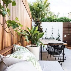 an outdoor patio with plants and furniture