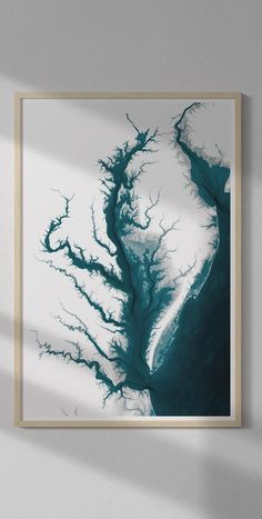 an aerial view of a river in the middle of winter, framed on a wall