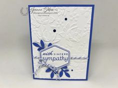 a close up of a card with blue and white flowers on it, which reads much linder sympathy